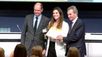 Giulia Rorato je prejela priznanje iz rok komisarja Oettingerja in vodje prevajalske službe Martikonisa