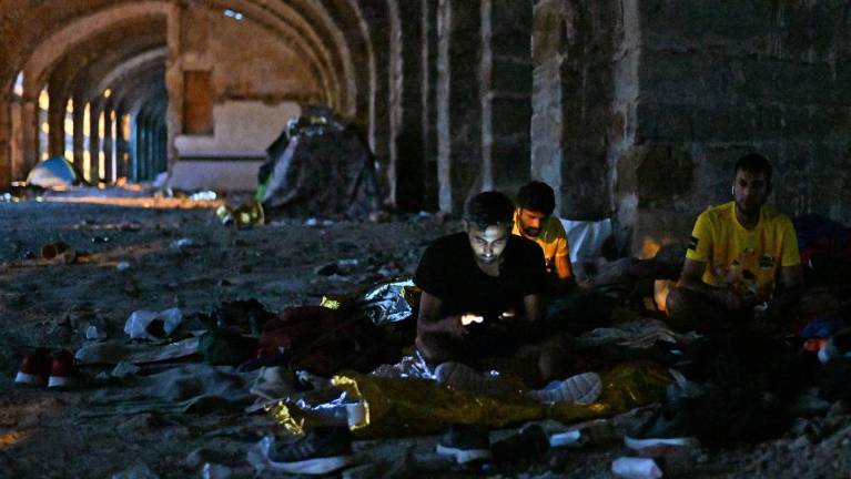 V kanduali spijo med kupi smeti